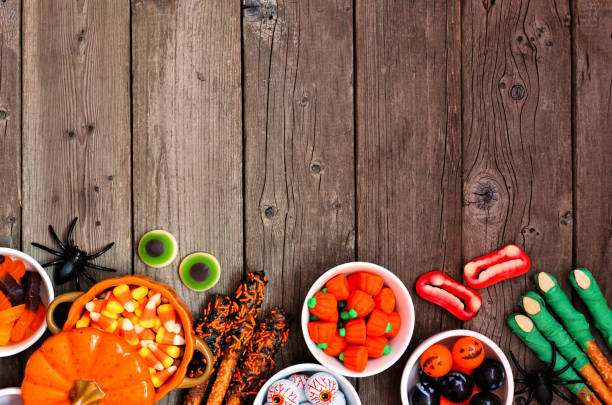 istock Halloween candy buffet border over a rustic wood background 1267398793