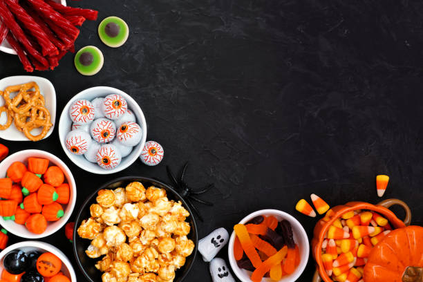istock Halloween candy buffet corner border over a black stone background 1267400419