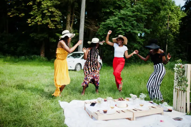 Photo of Group of african american girls celebrating birthday party outdoor with decor.