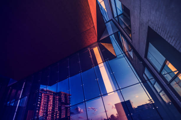 Abstract photography of a mixed use distric Residential building reflected into a newly built office building. abstract view stock pictures, royalty-free photos & images