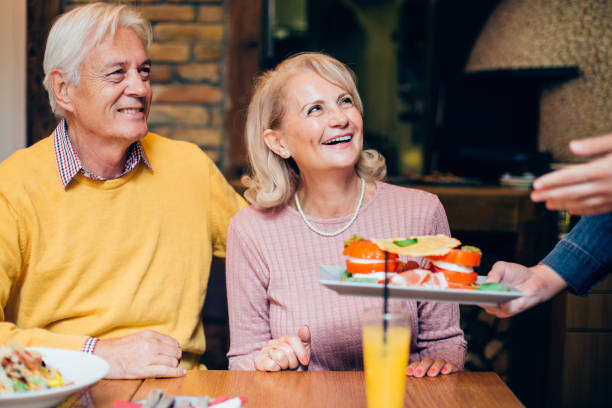 istock Happy mature couple getting their order at the restaurant 1267417098