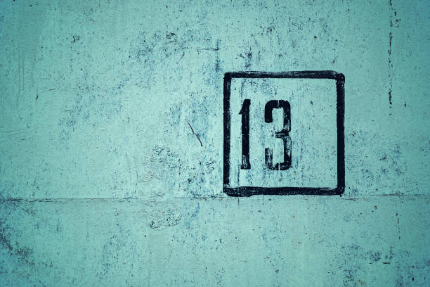 nummer 13 is gestencild in zwart frame op groene betonnen muur, kopieerruimte - green friday stockfoto's en -beelden