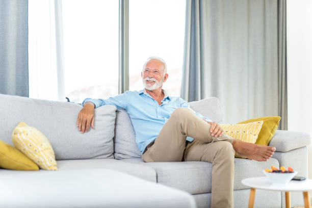 istock Mature man relaxing at home on sofa. 1267419064