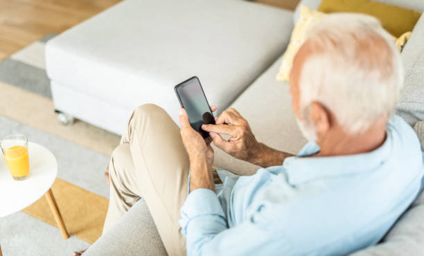 istock Senior man using phone at home. 1267419102