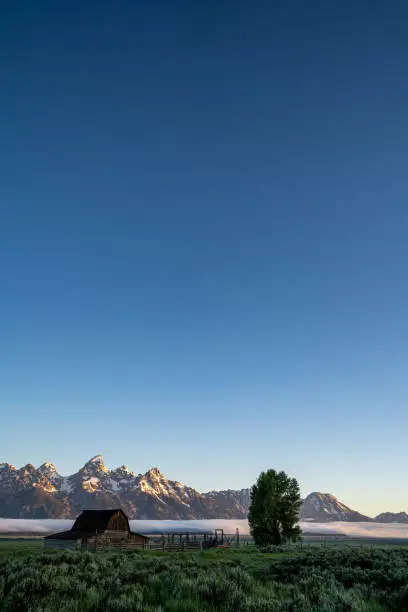 Photo of John Moulton Barn in Grand Teton National Park in the Mormon Row area at sunrise. Negative Space composition