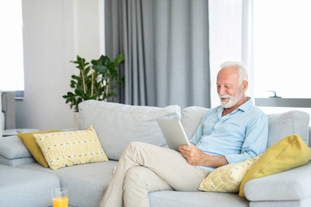 istock Happy senior man using digital tablet in the living room. 1267420182