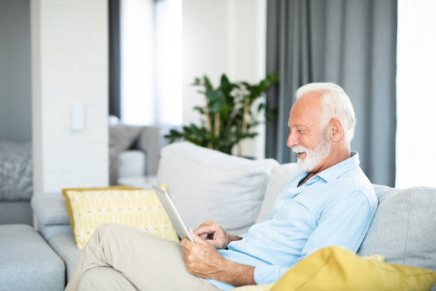 istock Happy senior man using digital tablet in the living room. 1267420200