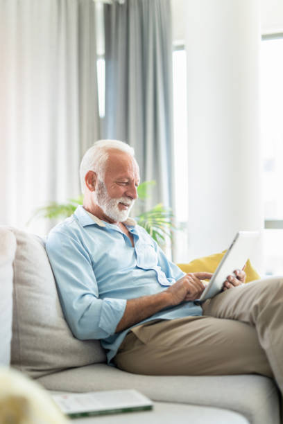 istock Happy senior man using digital tablet in the living room. 1267420206