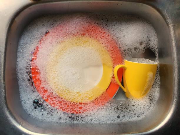 istock Colourful crockery in soapy water. 1267420279