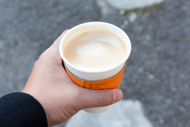 istock Hand holding cup of hot latte coffee 1267425173