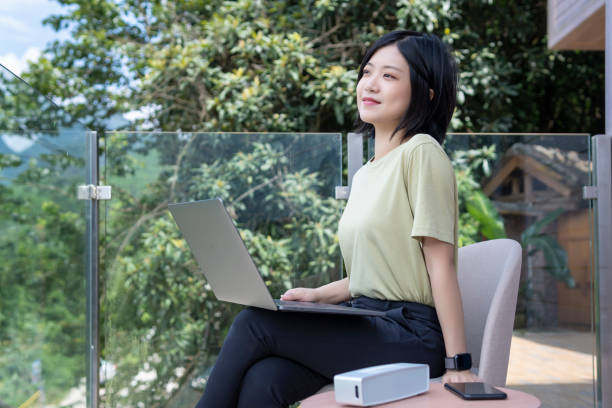istock A female freelancer using a laptop to work outdoors in the journey 1267427359