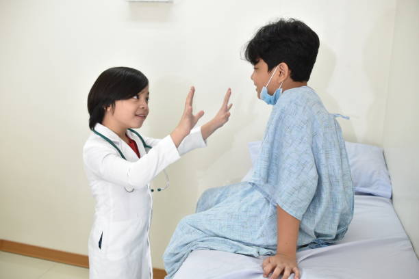 istock Young Boy Doctor Examines his Young Patient. 1267430180