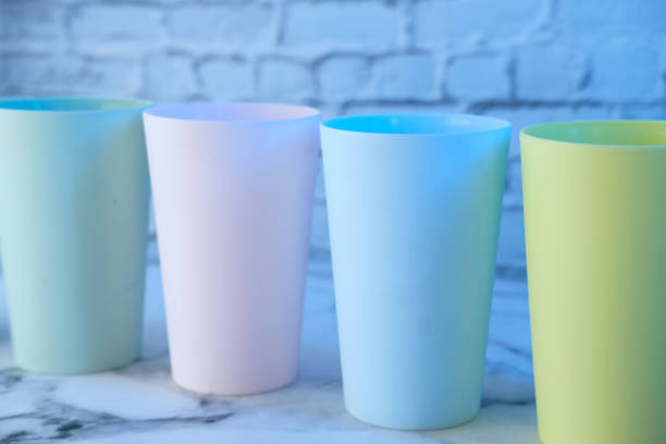 istock Plastic glass of various color on table. 1267437605