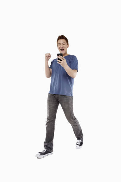istock Man cheering after reading text message on smart phone 1267437636