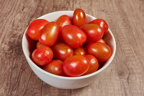 istock Cherry tomatoes in white bowl over wooden table 1267438530