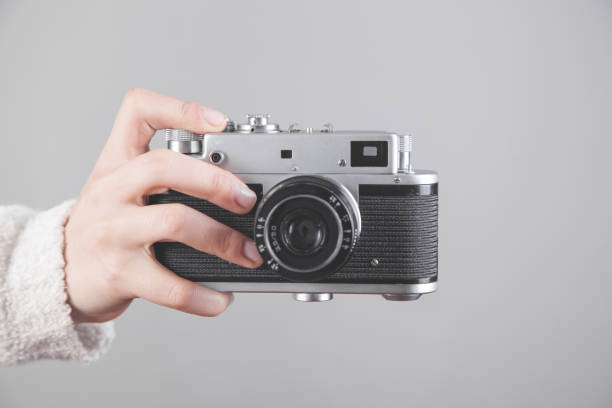 istock Girl holding a retro camera in office. 1267443075