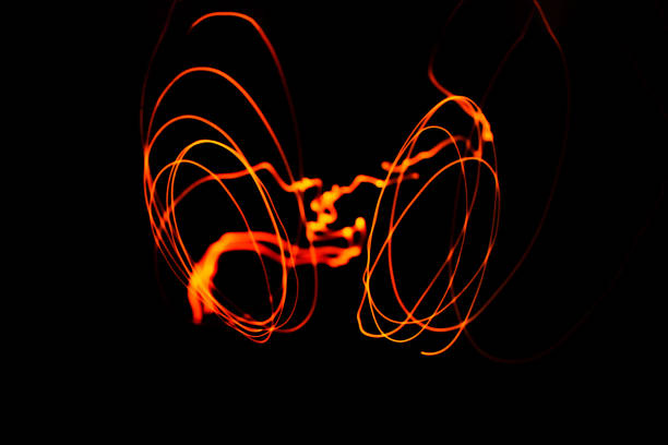 istock Creative conceptual fine art photography motion blur sparkle light trail on dark background copy space for text. Artistic design by lamp fire flame line at night slow shutter speed of camera exposure. 1267446925