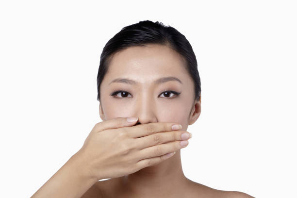 istock Woman with hand over her mouth 1267448934