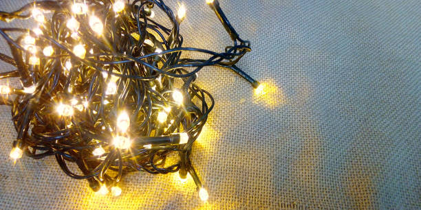 istock Christmas lights ball on cloth background copy space 1267449036