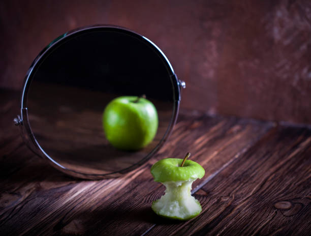 Apple reflecting in  the mirror surrealistic picture abstract vision concept you are not you how others see you how you see yourself body conscious stock pictures, royalty-free photos & images