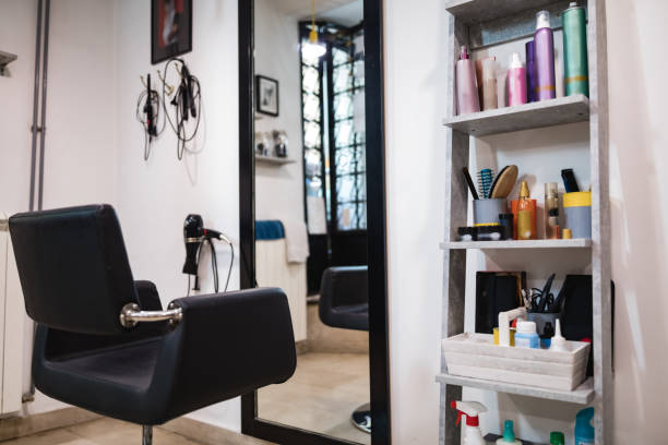 istock Empty hair salon interior with chairs and mirrors. 1267453130