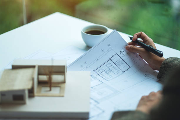 istock An architect working on an architecture house model with shop drawing paper in the office 1267453966