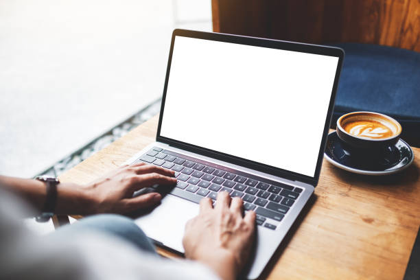 istock a woman using and typing on laptop keyboard with blank white desktop screen in cafe 1267454007