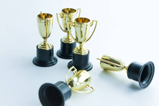 istock golden winner cups on a white background. Competitions concept. 1267455057