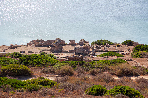 Ruins of old Phoenicians town of Tharros located on San Giovanni in Sinis peninsula seen from the observation tower over the hill.\nCabras. Sardinia. Italy