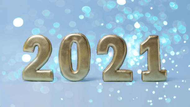 istock New year 2021. Gold numbers stand on a blue background. Blue bokeh background. Selective focus, banner 1267461322