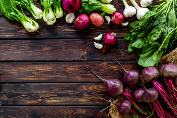 istock Vegetables harvest with green tops on wooden table top view frame copy space 1267461584