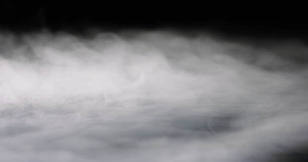 Thick Cloud Of Fog heavy thick fog filling a black background. fog stock pictures, royalty-free photos & images