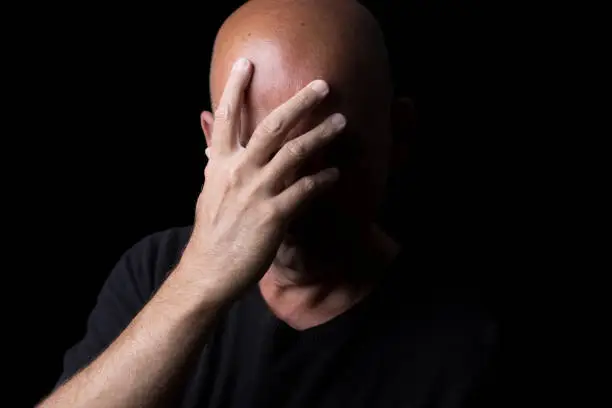 a male self portrait with black background