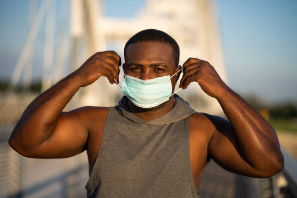 istock Young man exercising outdoor with protective mask 1267465131