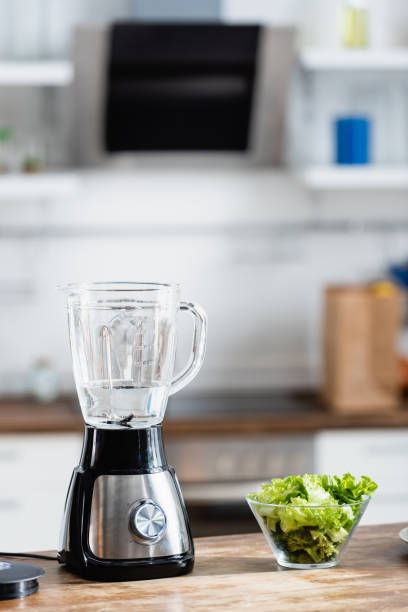 istock water in blender near green and fresh lettuce on table 1267466077