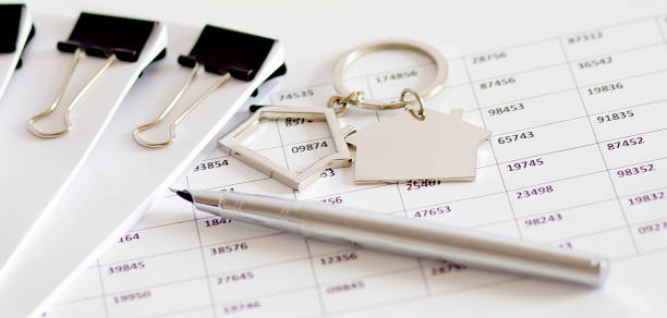 Small house model keys pen on the mortgage document stock photo