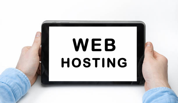 istock Male hands holding tablet pc with text WEB HOSTING on white background 1267466923