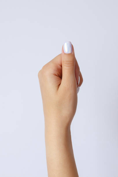 istock Gesture and sign, hand holds something on a light background 1267469242