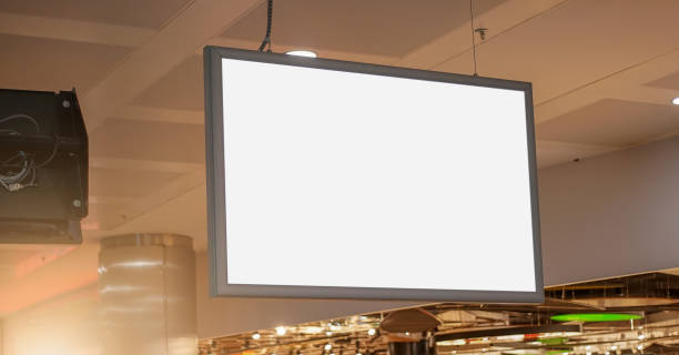 istock empty white screen with blank mock-up place for commercial advertising information hanging in store hall 1267470032
