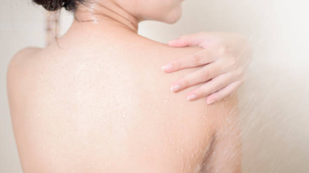 istock Happy  beautiful woman is taking a shower 1267470881