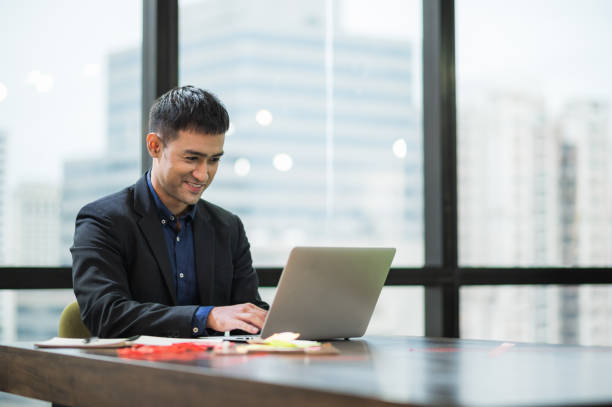 istock Young asian businessman working with laptop in office. 1267470887