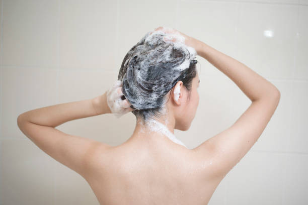 istock Happy  beautiful woman is taking a shower 1267470965
