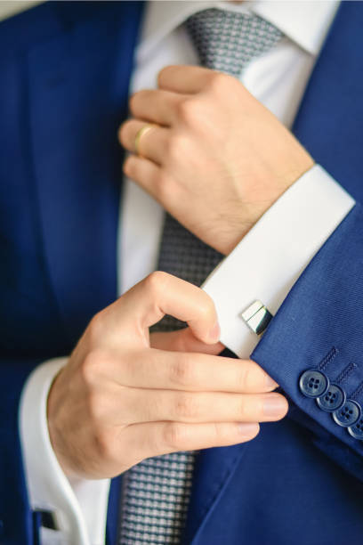 istock Groom or businessman fasten cufflink 1267471828