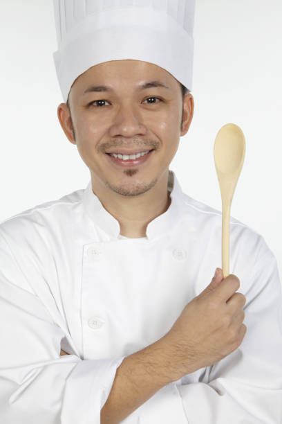 istock Asian chef holding wooden spoon 1267471936