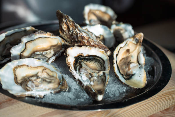istock Oysters on the black plate on the table. 1267471991
