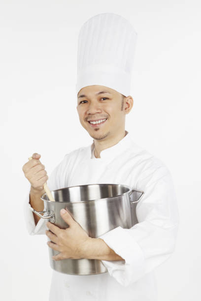 istock Asian chef cooking with a stew pot and a wooden spoon 1267473031