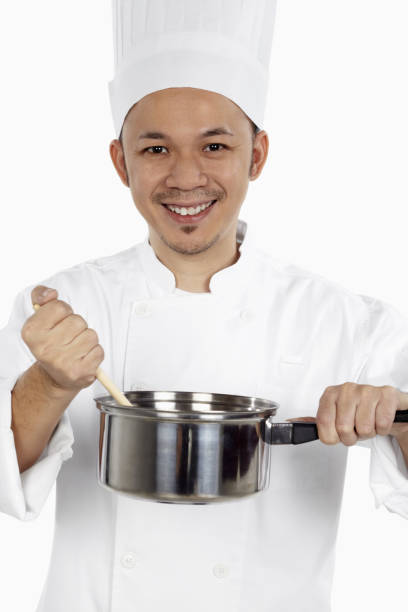 istock Asian chef cooking with saucepan 1267473499