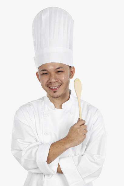 istock Asian chef holding wooden spoon 1267473590