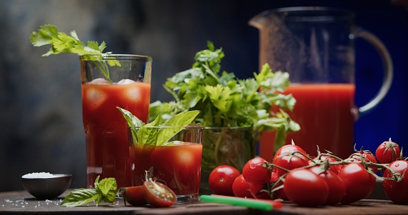 Serving tomato juice on the dark grey background
