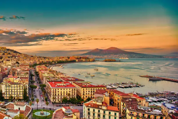 Looking over the Bay of Naples towards Mount Vesuvius in the background. Naples, Italian Napoli is the regional capital of Campania and the third-largest city of Italy, after Rome and Milan, with a population of almost 1million. It's the second-most populous metropolitan area in Italy and the 7th-most populous urban area in the European Union.